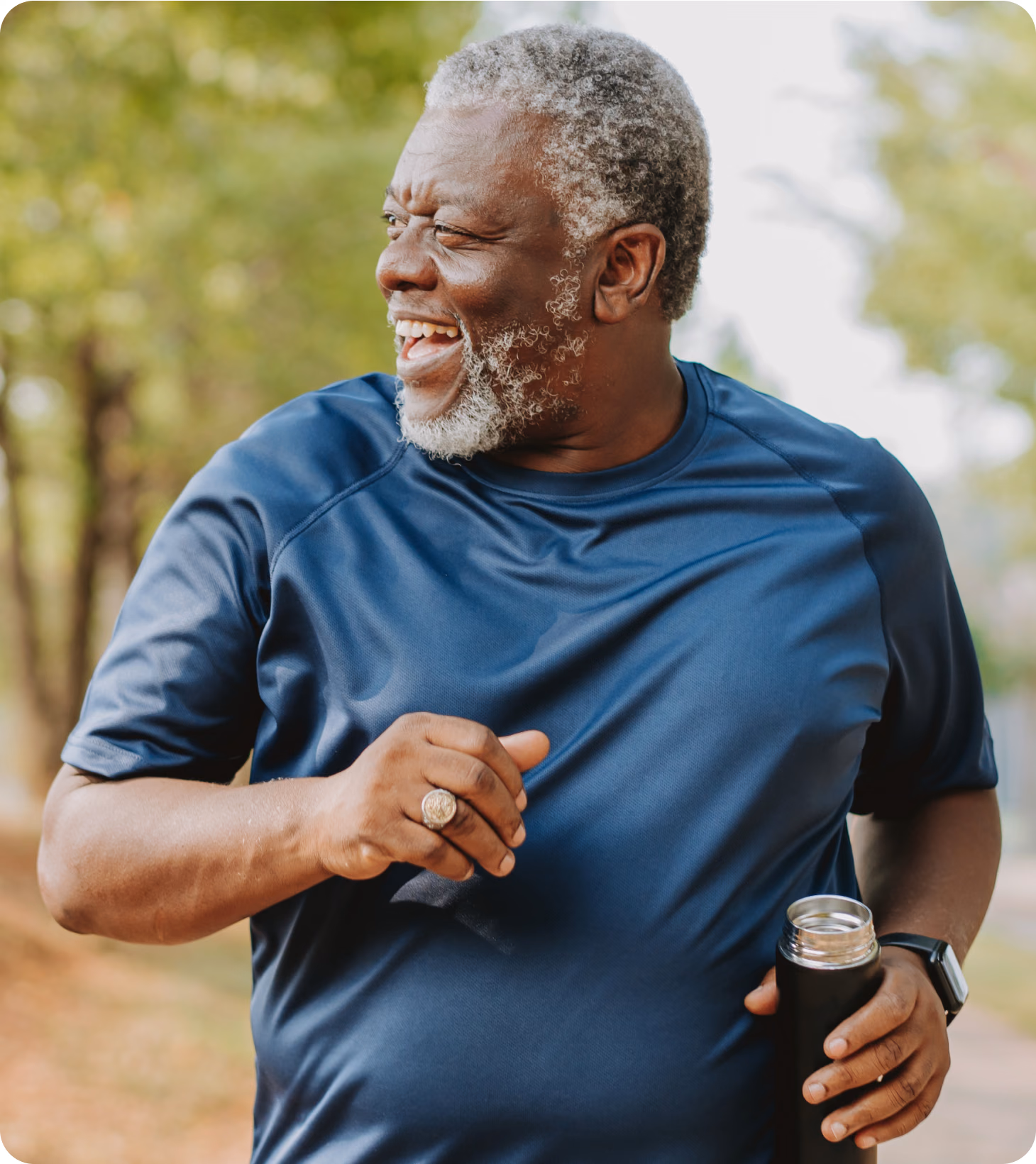 A black man in his early fifties, getting his steps in at the park.