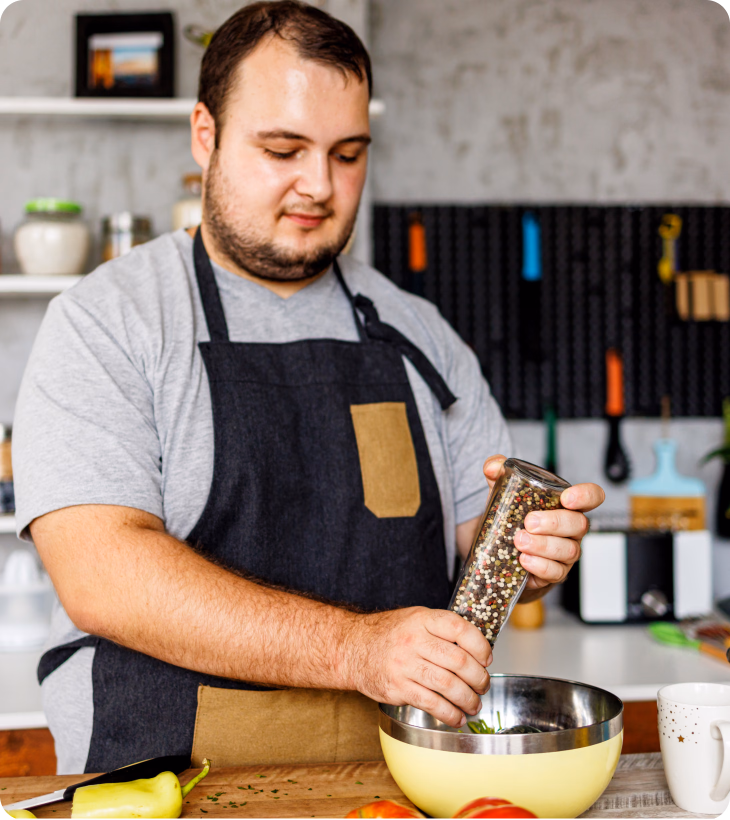 A middle-aged man in their kitchen making a healthy salad recipe.