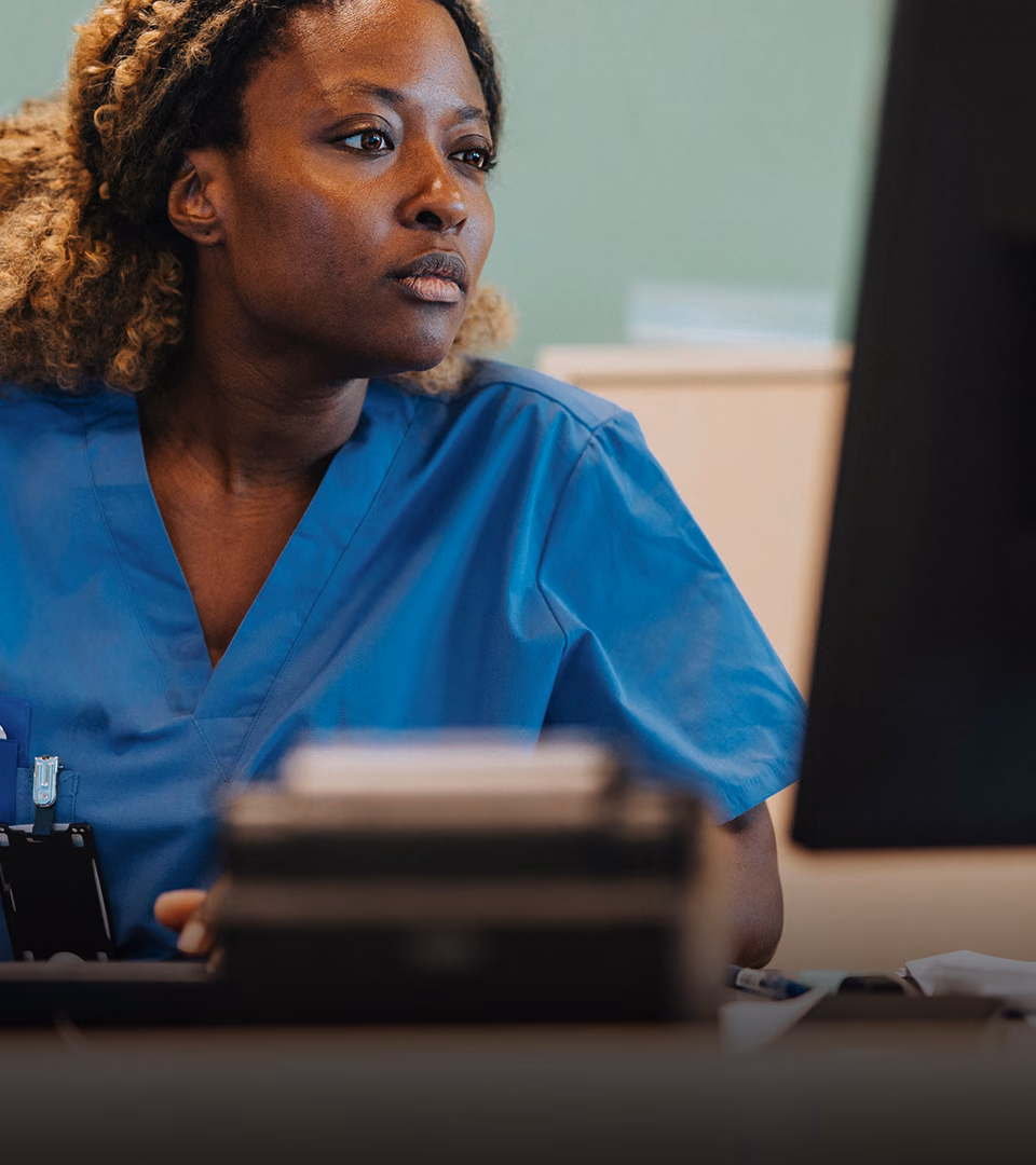 Clinical researcher at a study site, using a clinical trial management system.