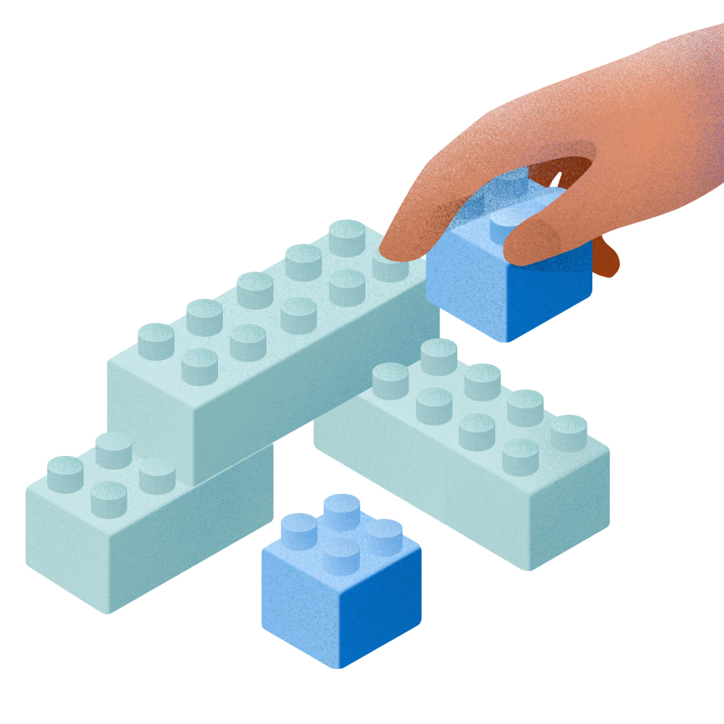 Illustration shows a hand building a structure with interlocking bricks