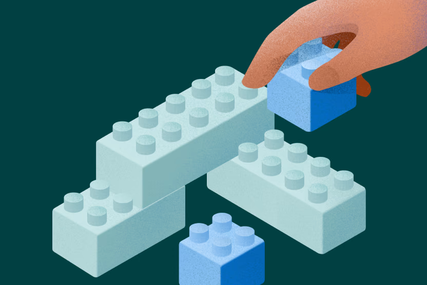 Illustration shows a hand building a structure with interlocking blue bricks on a dark green background